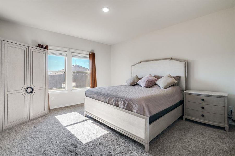 Carpeted bedroom with baseboards