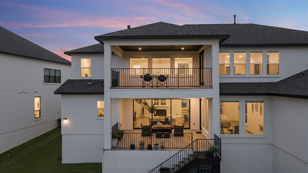 The property features a two-story exterior with a covered balcony and covered patio, both equipped with railings