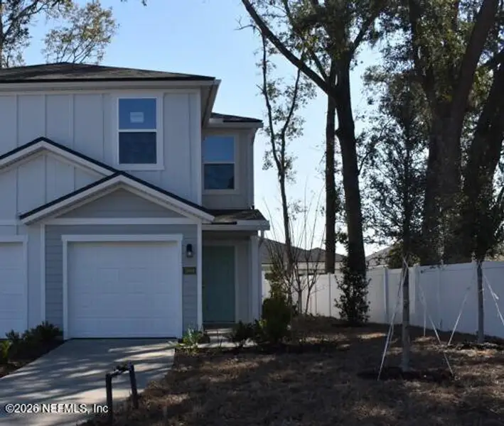 Front exterior of a new home in Irongate Villas, Jacksonville, FL, highlighting curb appeal (Image 2).