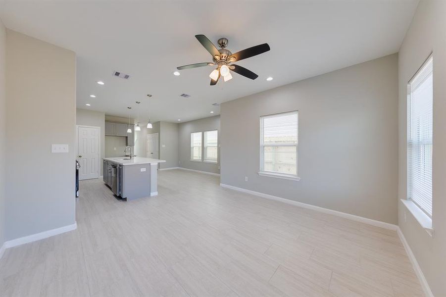 The dining room is bathed in beautiful natural light streaming in from large windows, creating a bright and inviting atmosphere. This well-lit space is perfect for family meals or hosting dinner parties, offering a warm and cheerful setting for any occasion.