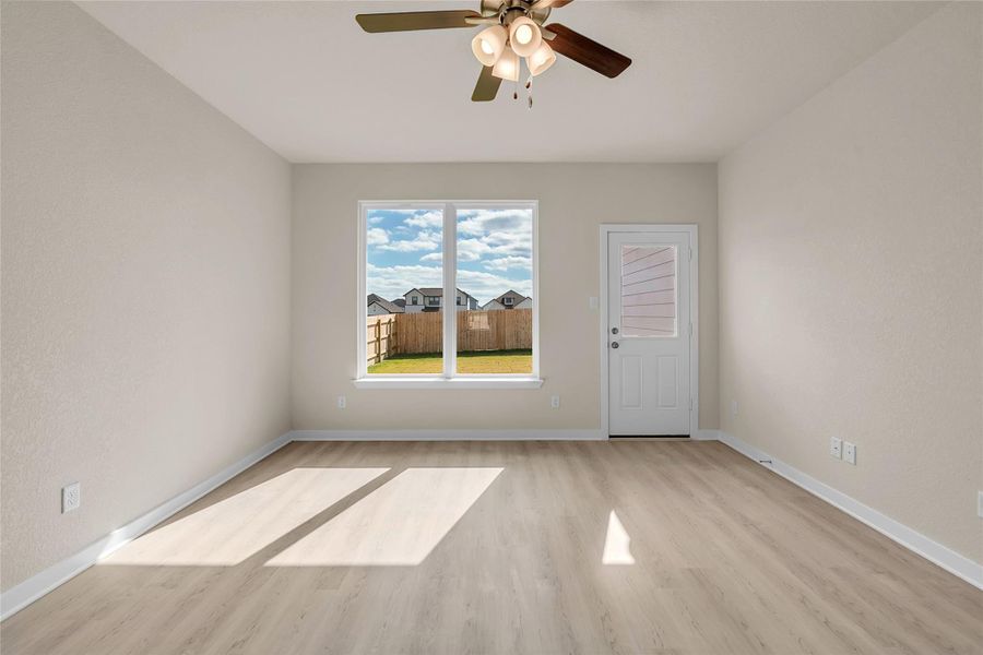 Spare room featuring light wood-style flooring and a ceiling fan