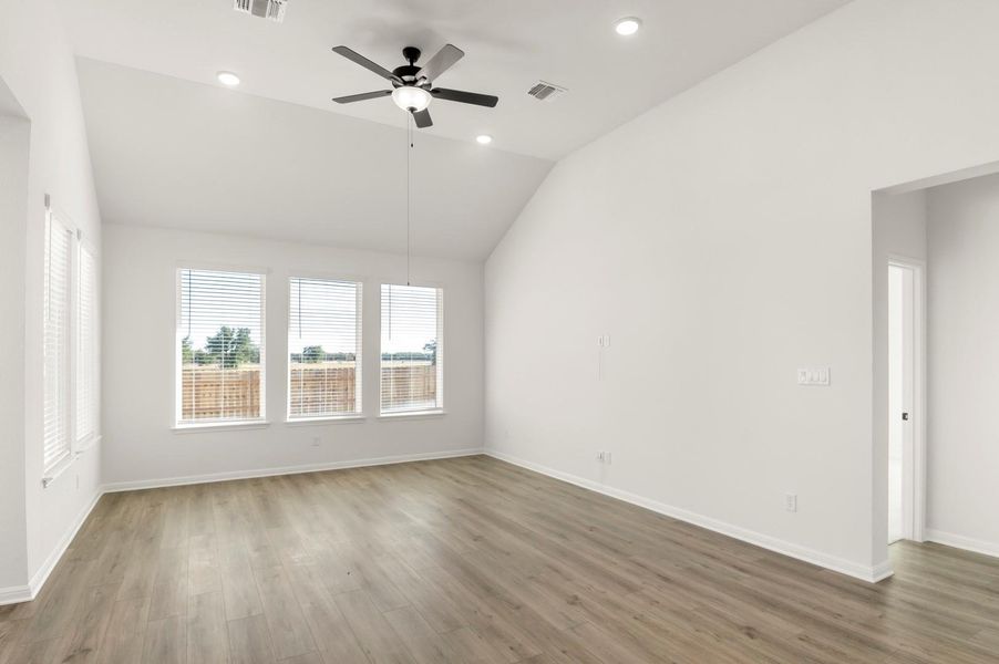 Unfurnished room with vaulted ceiling, wood finished floors, a ceiling fan, and recessed lighting