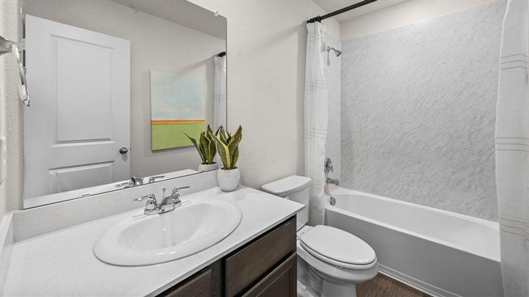 Bathroom featuring vanity and shower / bath combo with shower curtain