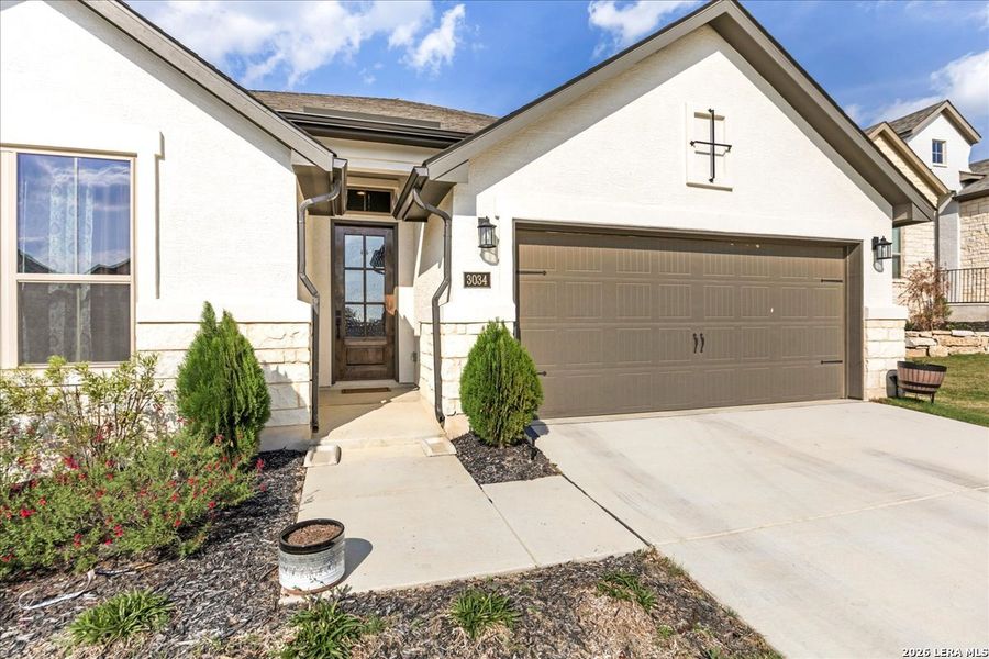 Front exterior of a new home in , Bulverde, TX, highlighting curb appeal (Image 24).