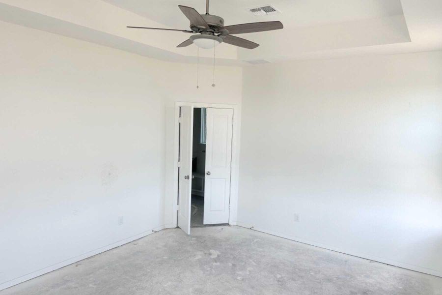 Unfurnished bedroom featuring a ceiling fan and concrete flooring Unfurnished bedroom featuring a ceiling fan and concrete flooring