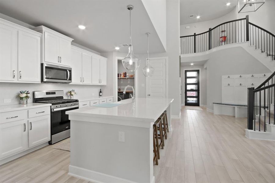 Beautiful immaculate kitchen that leads to laundry room.