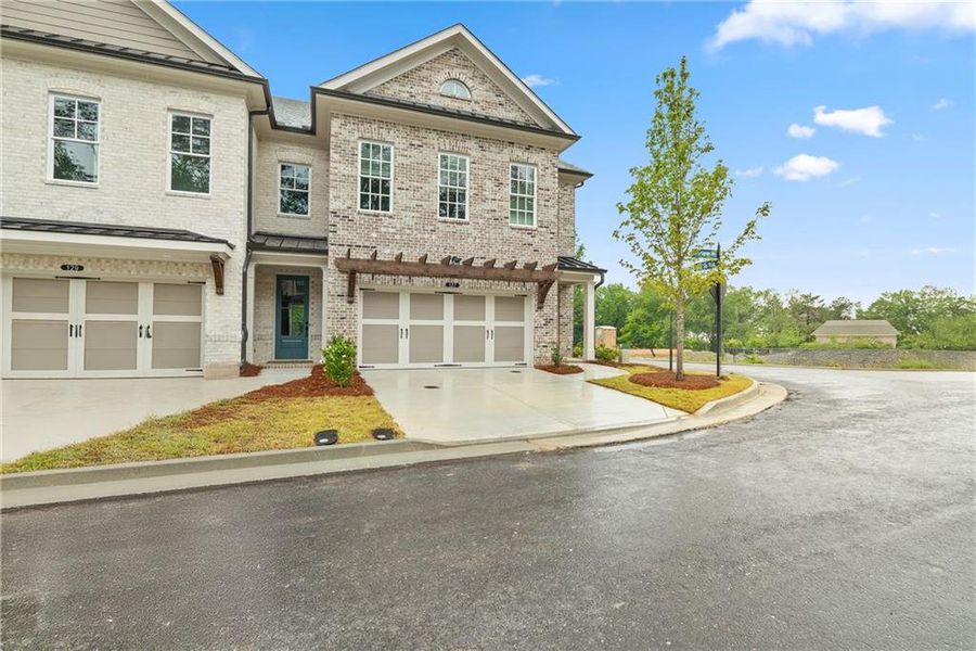 Front exterior of a new home in Waterside Townhomes, Peachtree Corners, GA, highlighting curb appeal (Image 12).