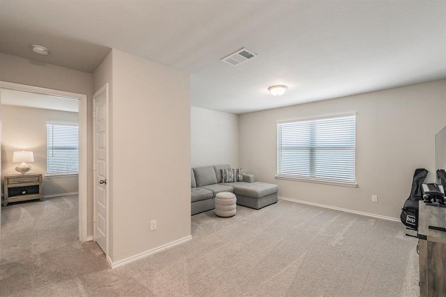 Sitting room featuring light carpet and baseboards