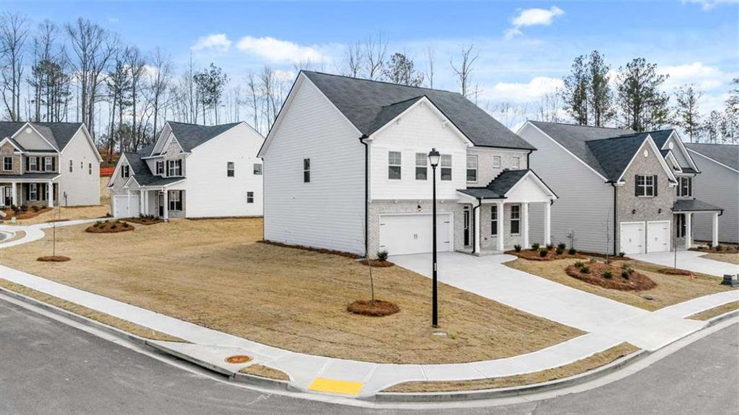 Front exterior of a new home in Water Oak Estates, Lawrenceville, GA, highlighting curb appeal (Image 22).