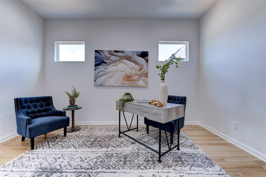 Flex room detail showing high ceilings, dual clerestory windows on back wall, hardwood floors, and clean neutral finishes throughout.