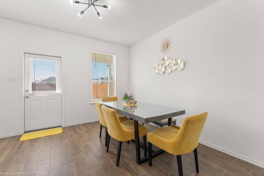 Dining room featuring baseboards and dark wood-style flooring