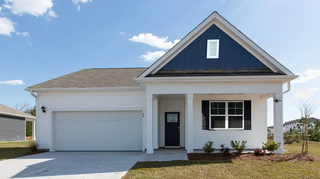Front exterior of a new home in Saltgrass Landing, Winnabow, NC, highlighting curb appeal (Image 1). Front exterior of a new home in Saltgrass Landing, Winnabow, NC, highlighting curb appeal (Image 1).