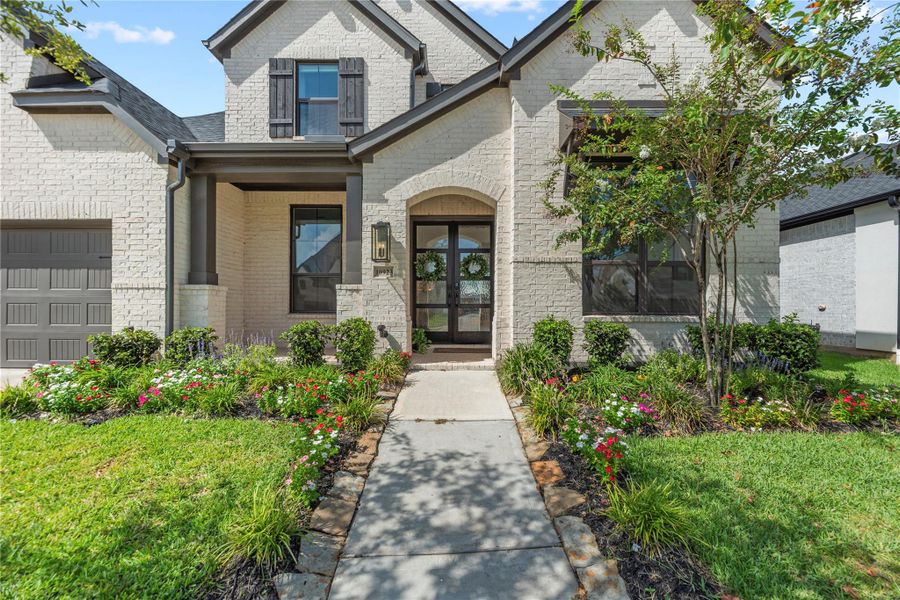 Front exterior of a new home in Sienna, Missouri City, TX, highlighting curb appeal (Image 22).
