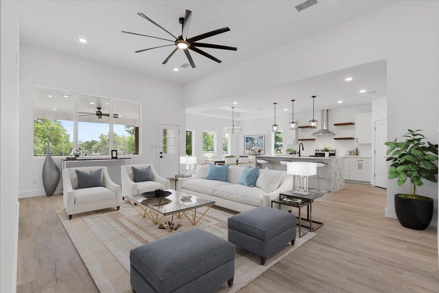 Living area featuring a ceiling fan, light wood-style flooring, and recessed lighting Living area featuring a ceiling fan, light wood-style flooring, and recessed lighting