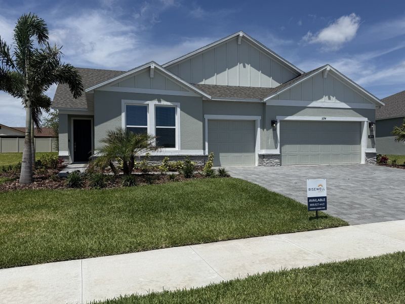 Front exterior of a new home in Country Club Estates, Palm Bay, FL, highlighting curb appeal (Image 1). Front exterior of a new home in Country Club Estates, Palm Bay, FL, highlighting curb appeal (Image 1).
