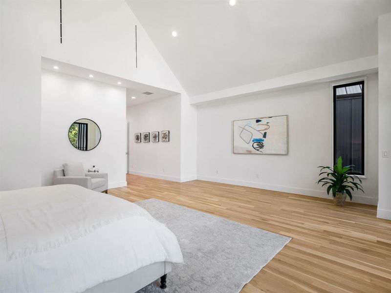 Bedroom featuring light wood-style flooring, recessed lighting, and lofted ceiling