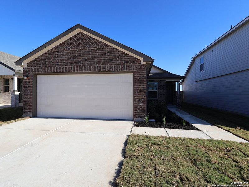 Front exterior of a new home in Park Place, New Braunfels, TX, highlighting curb appeal (Image 23). Front exterior of a new home in Park Place, New Braunfels, TX, highlighting curb appeal (Image 23).