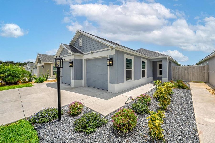 Front exterior of a new home in , The Villages, FL, highlighting curb appeal (Image 23).