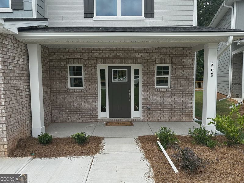 Front exterior of a new home in Canterbury Villas, Carrollton, GA, highlighting curb appeal (Image 2).