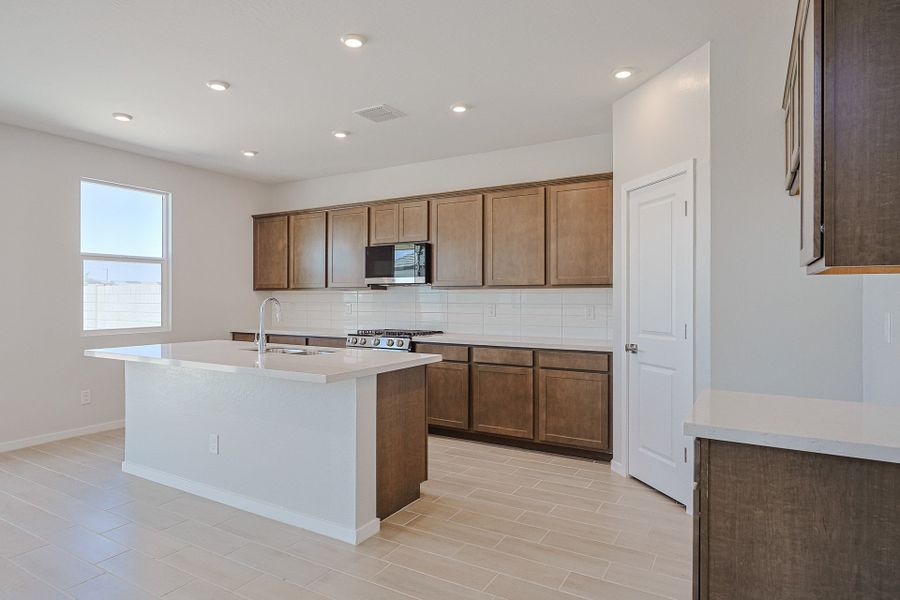 A kitchen with wooden cabinets. A kitchen with wooden cabinets.