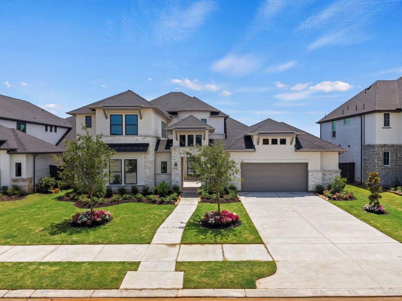 Front exterior of a new home in Harvest Green, Richmond, TX, highlighting curb appeal (Image 1). Front exterior of a new home in Harvest Green, Richmond, TX, highlighting curb appeal (Image 1).