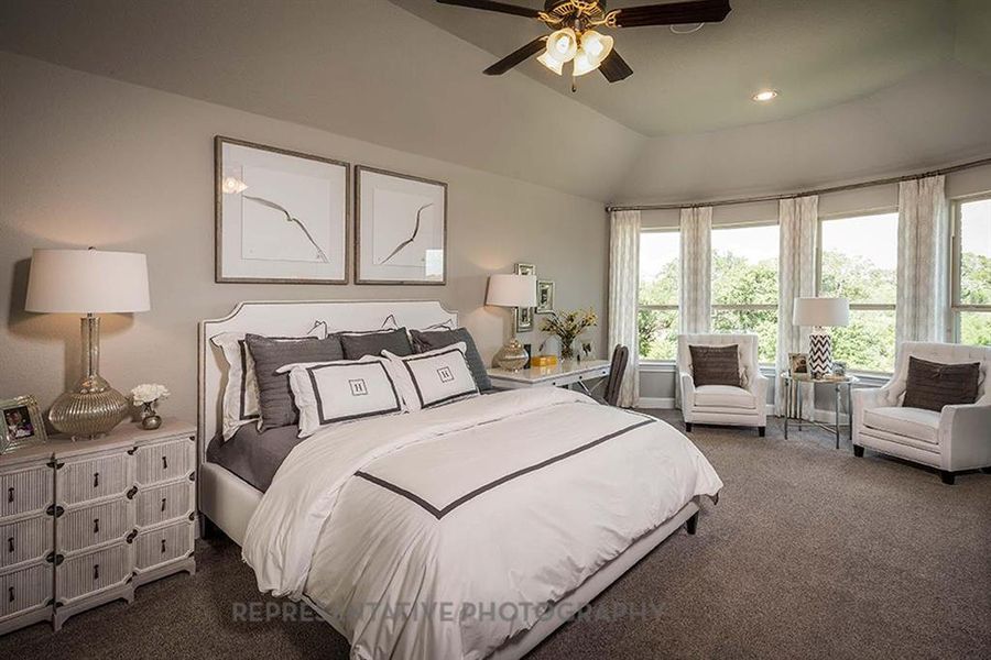 Bedroom with dark colored carpet, ceiling fan, vaulted ceiling, and recessed lighting Bedroom with dark colored carpet, ceiling fan, vaulted ceiling, and recessed lighting