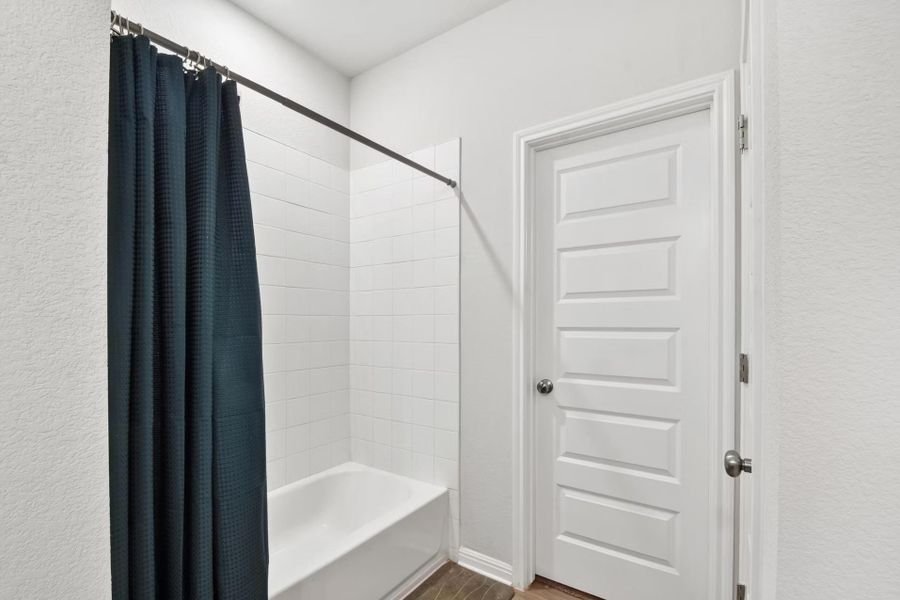 Bathroom features a bright white tub and subway tile surround Bathroom features a bright white tub and subway tile surround