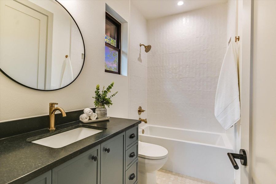 One of the two full upstairs bathrooms. This one is a Jack-and-Jill and features beautiful finishes and tilework. One of the two full upstairs bathrooms. This one is a Jack-and-Jill and features beautiful finishes and tilework.