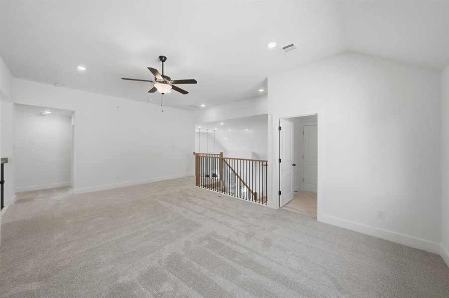 Unfurnished room featuring light carpet, recessed lighting, lofted ceiling, and a ceiling fan Unfurnished room featuring light carpet, recessed lighting, lofted ceiling, and a ceiling fan