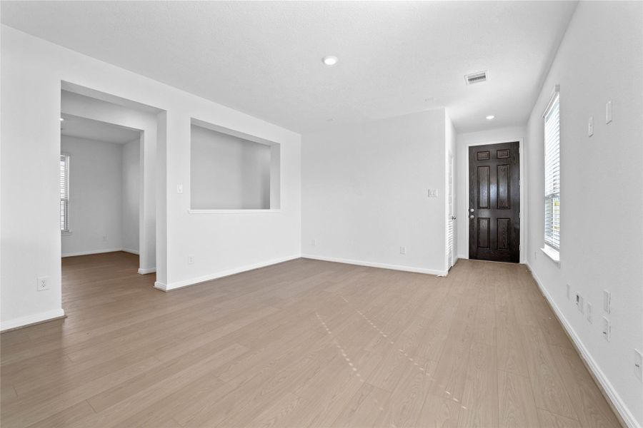 Walking into this gorgeous home, you get a feel of just how bright and open everything is, this space showcases high ceilings, recessed lighting, gorgeous Bandera vinyl plank flooring in Toasted Sienna, fluid floor plan, custom paint, and plenty of windows allowing in the natural light!