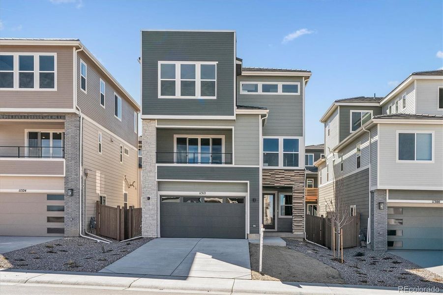 Front exterior of a new home in The Summit at Meridian, Englewood, CO, highlighting curb appeal (Image 1). Front exterior of a new home in The Summit at Meridian, Englewood, CO, highlighting curb appeal (Image 1).