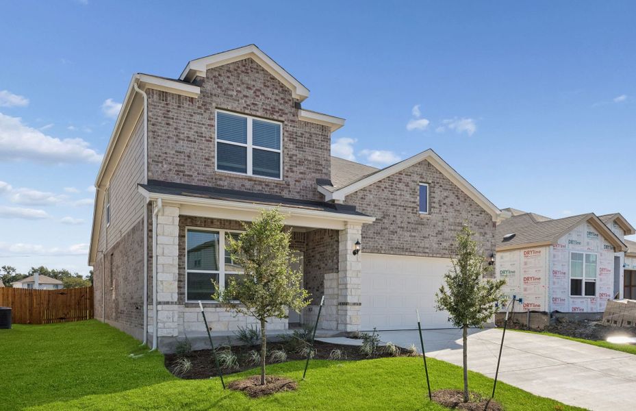 Front exterior of a new home in Lagos, Manor, TX, highlighting curb appeal (Image 23). Front exterior of a new home in Lagos, Manor, TX, highlighting curb appeal (Image 23).