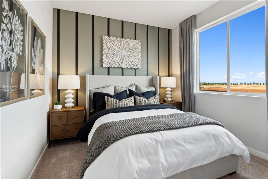 A bedroom with a large window. A bedroom with a large window.
