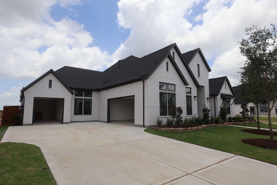 Front exterior of a new home in Dunham Pointe, Cypress, TX, highlighting curb appeal (Image 17). Front exterior of a new home in Dunham Pointe, Cypress, TX, highlighting curb appeal (Image 17).