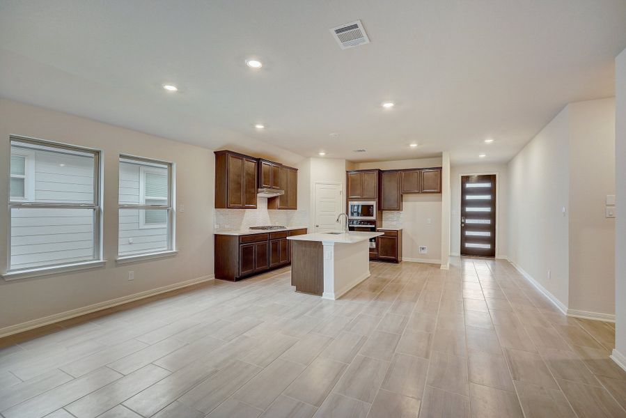 Dining room and kitchen in the Oleander floorplan at a Meritage Homes community.