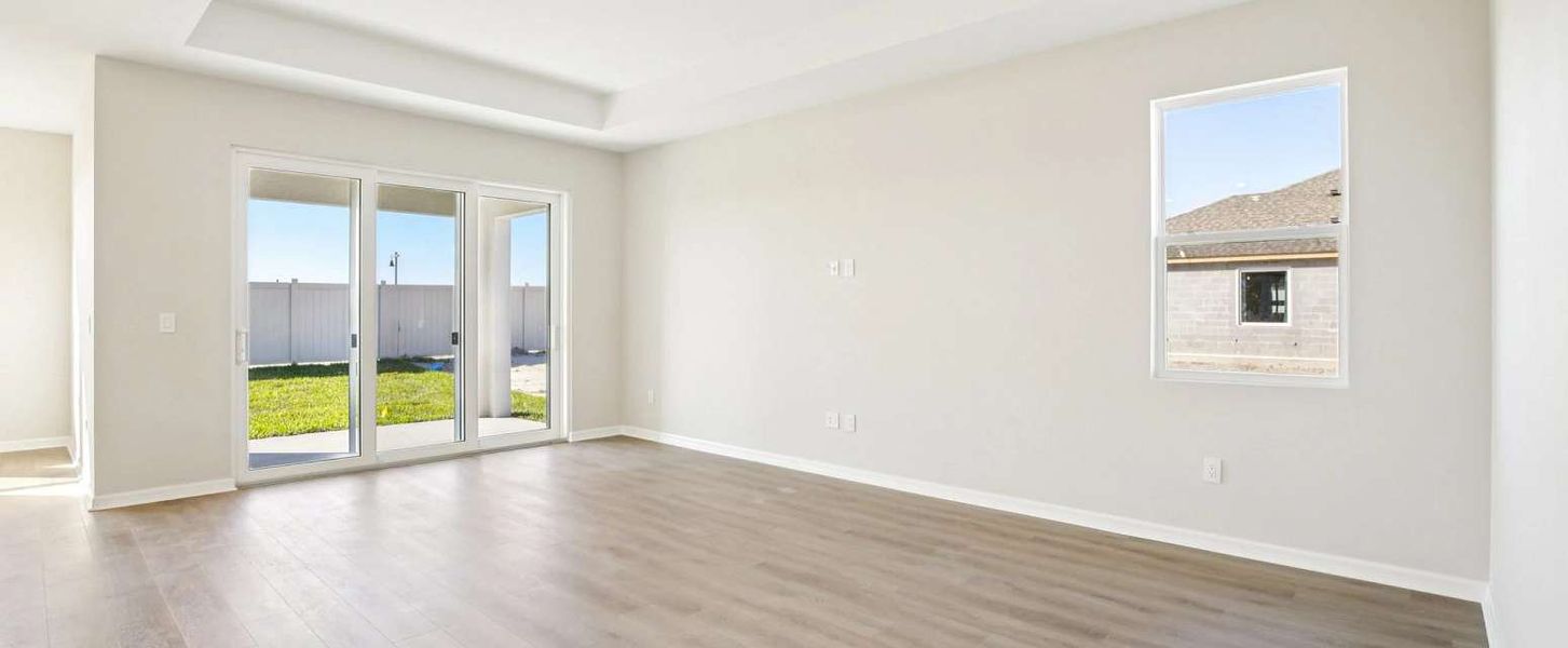 Spacious family room featuring a tray ceiling - Representative images and renderings are for illustrative purposes Spacious family room featuring a tray ceiling - Representative images and renderings are for illustrative purposes