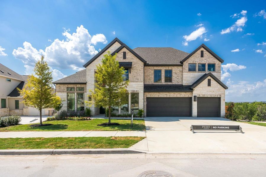 French country inspired facade with brick siding, a garage, concrete driveway, and roof with shingles French country inspired facade with brick siding, a garage, concrete driveway, and roof with shingles