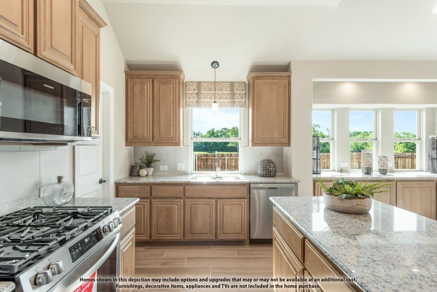 Kitchen with light wood cabinets, granite countertops, stainless steel appliances, and large windows