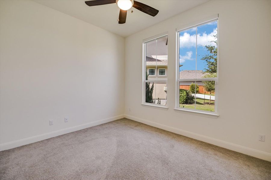 Spare room featuring carpet floors and a ceiling fan Spare room featuring carpet floors and a ceiling fan
