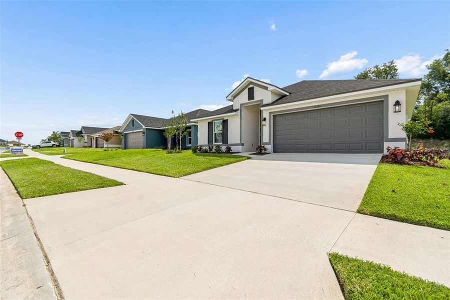 Front exterior of a new home in Abbey Glen, Dade City, FL, highlighting curb appeal (Image 29). Front exterior of a new home in Abbey Glen, Dade City, FL, highlighting curb appeal (Image 29).