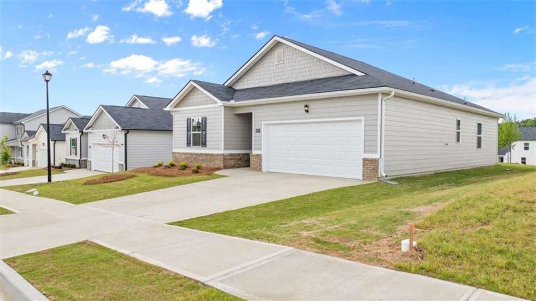 Front exterior of a new home in Champion's Run, Lithonia, GA, highlighting curb appeal (Image 19).