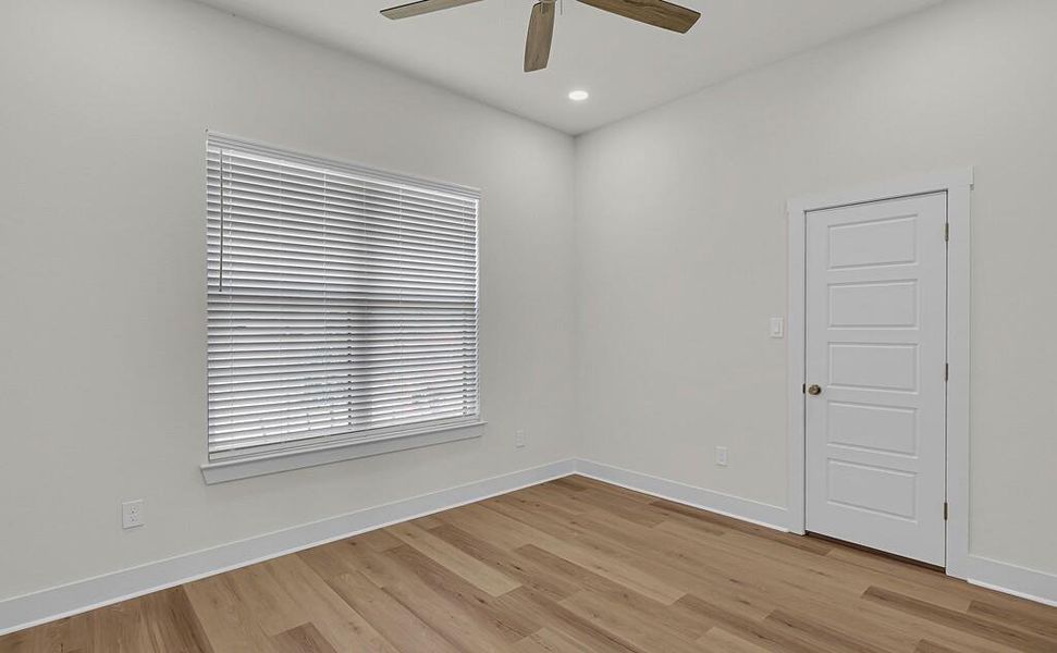Empty room with light wood-type flooring, recessed lighting, and a ceiling fan
