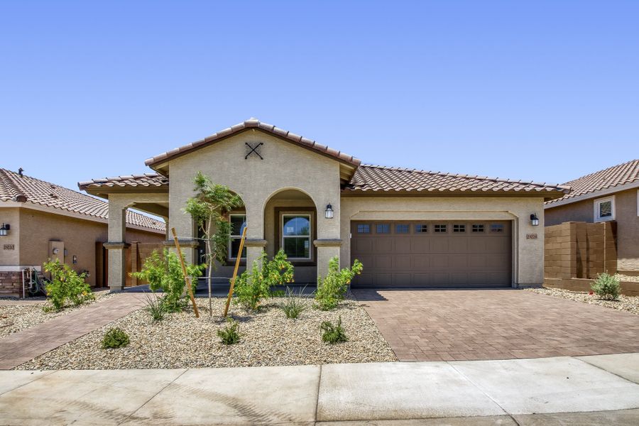 Front exterior of a new home in Asante Heritage | Active Adult, Surprise, AZ, highlighting curb appeal (Image 1). Front exterior of a new home in Asante Heritage | Active Adult, Surprise, AZ, highlighting curb appeal (Image 1).