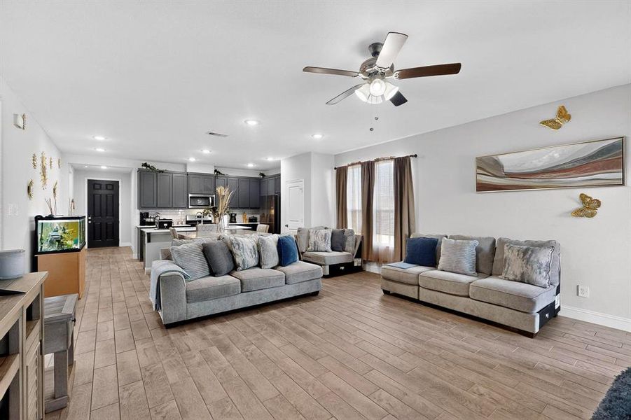 Living area featuring light wood-style floors, recessed lighting, and ceiling fan Living area featuring light wood-style floors, recessed lighting, and ceiling fan