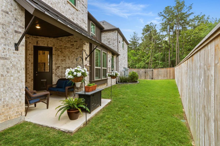 Stamped concrete patio area with room for seating - enjoy the expansive side yard which is one of the largest in the Townhome development -