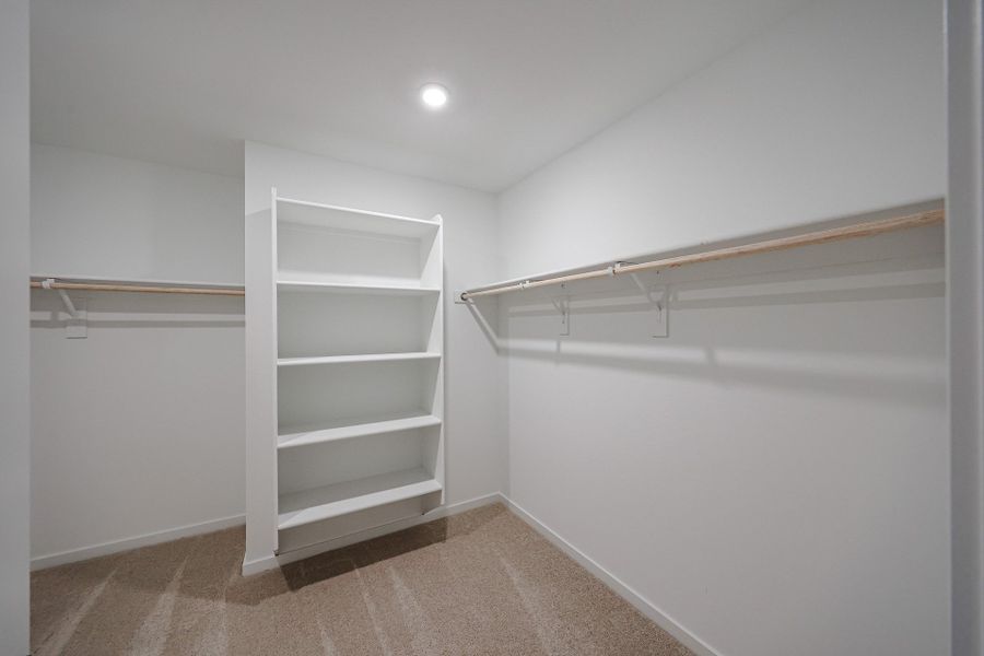 A white shelf in a room. A white shelf in a room.