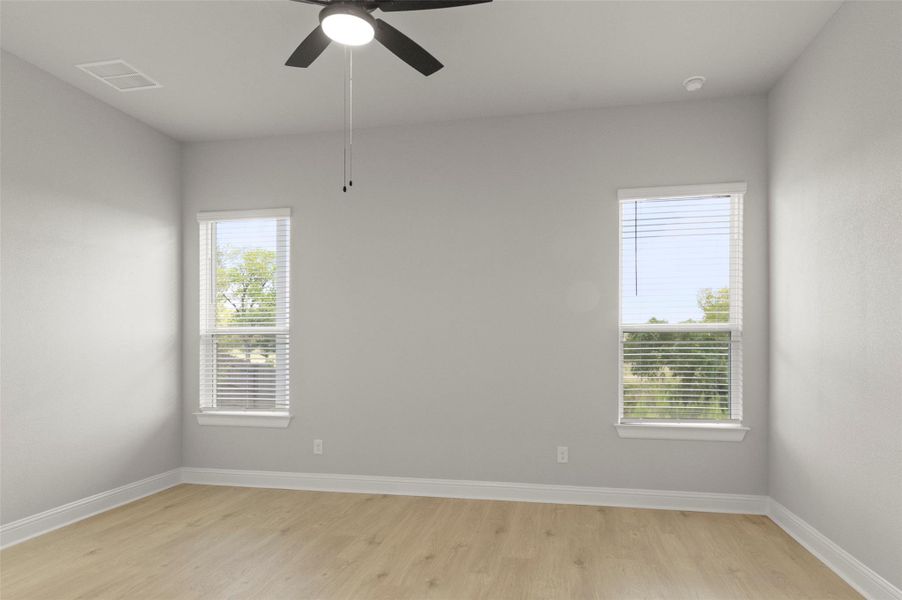 Spare room with light wood-style floors and a ceiling fan