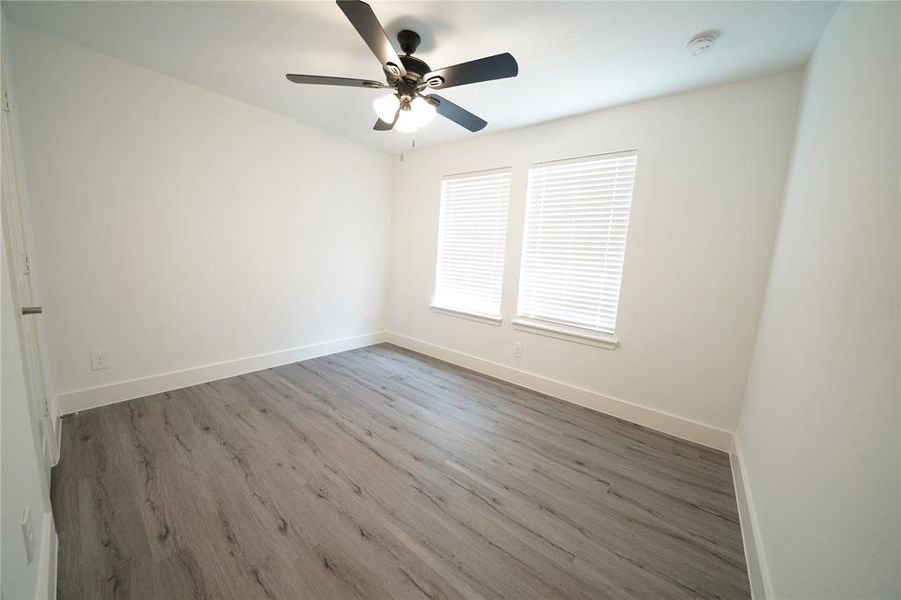 Empty room featuring wood finished floors and ceiling fan