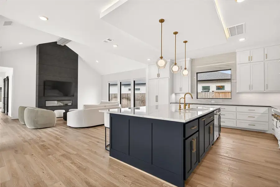 The open-concept design seamlessly connects the family room to the breakfast area and chef’s kitchen.