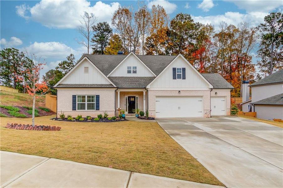 View of front of property with a garage and a front yard View of front of property with a garage and a front yard